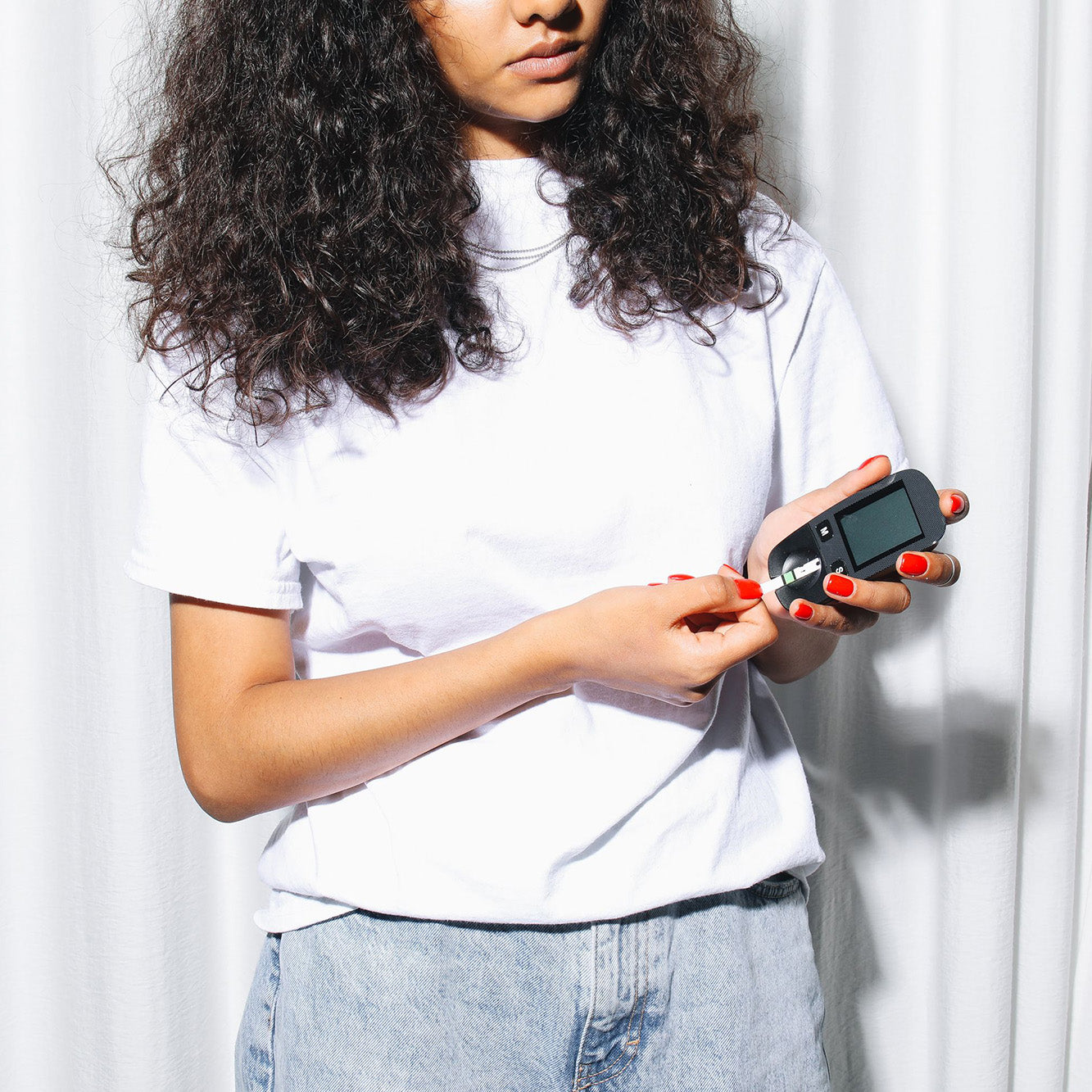 Young woman testing blood glucose for type 2 diabetes.