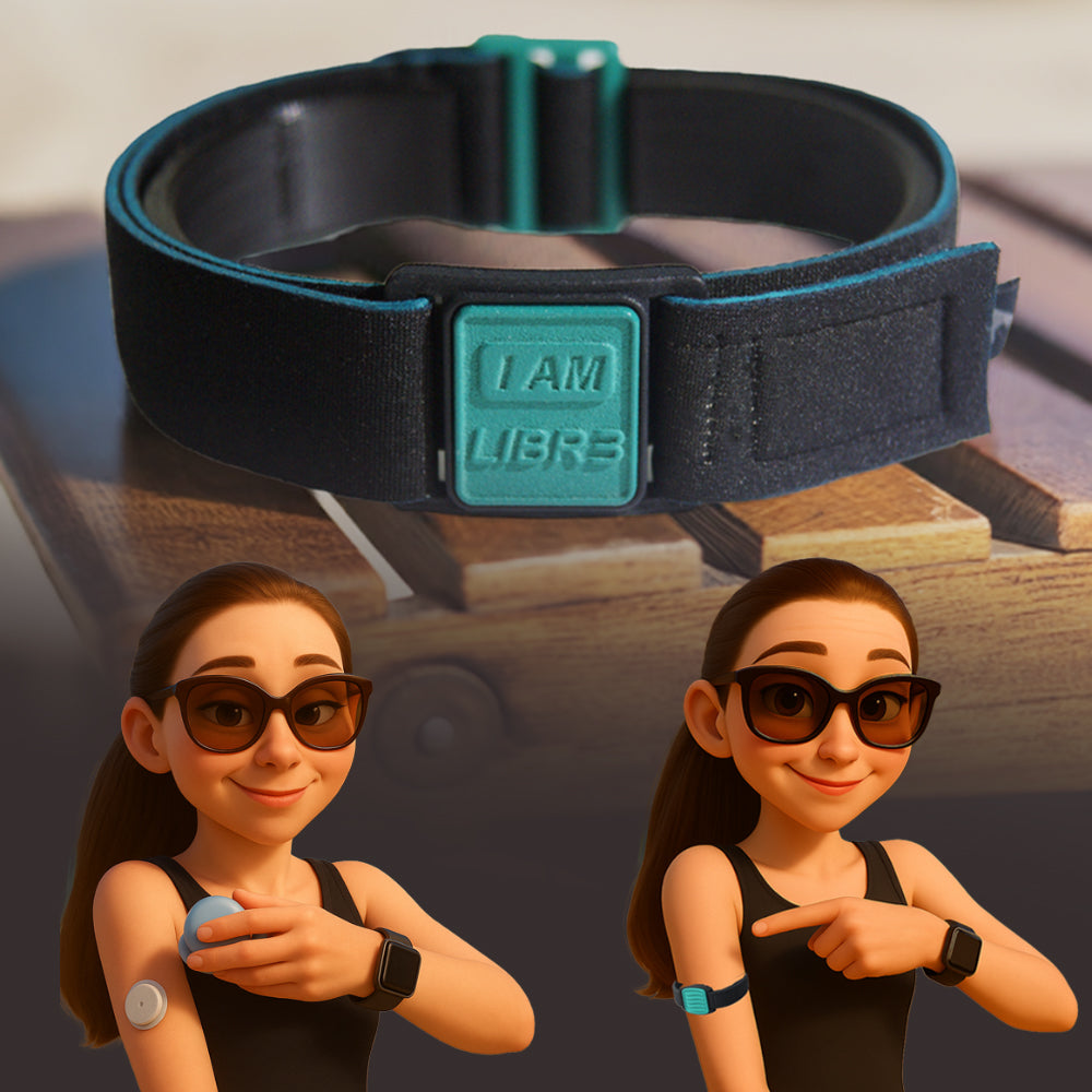 A black neoprene armband with teal 'I AM LIBR3' motif, designed to secure a FreeStyle Libre sensor, displayed on a wooden table.