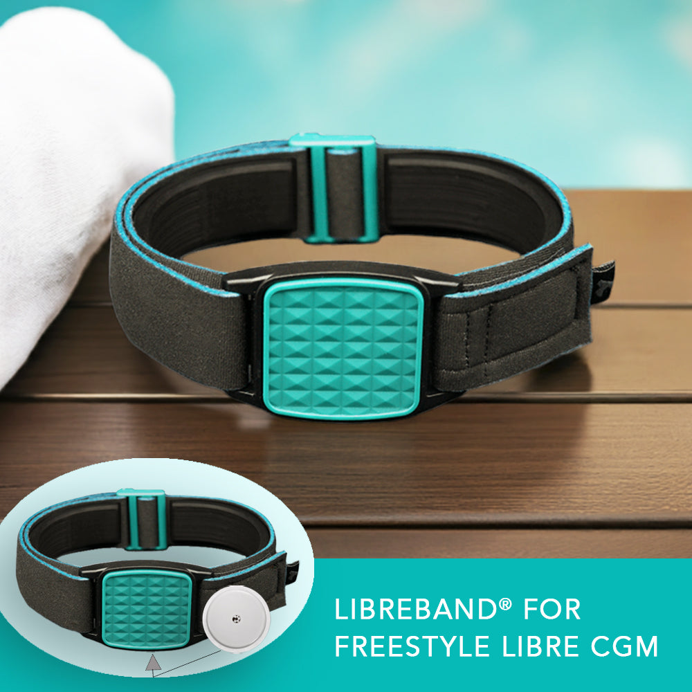 Libreband armband for Libre 2 cgm in teal with pyramids design and black neoprene strap. Shown next to white towel with swimming pool in background.