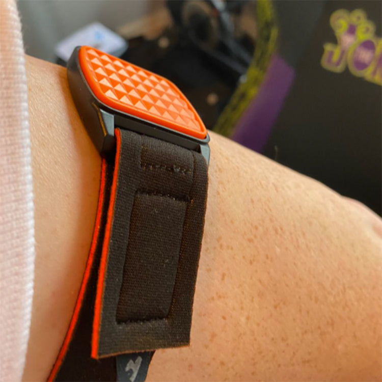 Libreband CGM armband for FreeStyle Libre with orange pyramids cover and black neoprene strap worn on upper arm, customer review photo