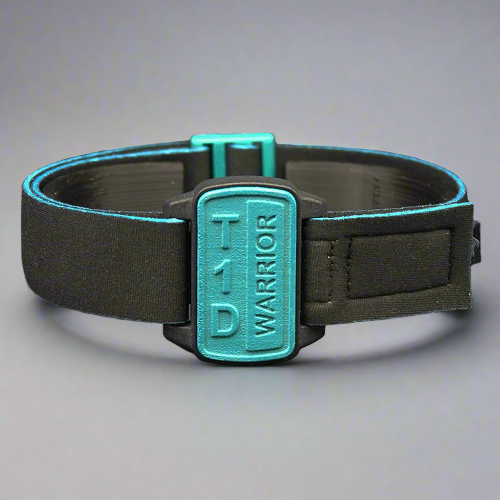 Dexband armband with black strap and teal cover with T1D Warrior wording.