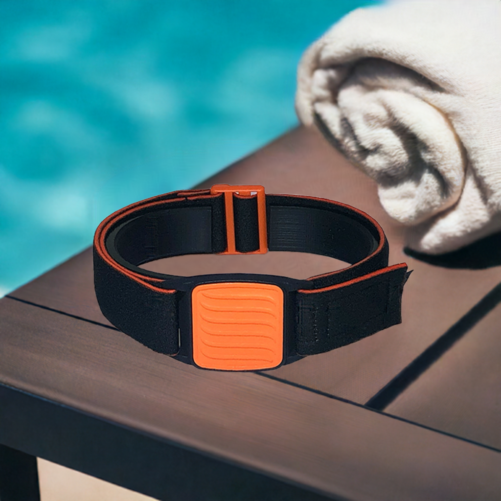 Dexband Armband for Dexcom G7, black strap with orange wave design cover.  Shown next to towel with swimming pool in background.l