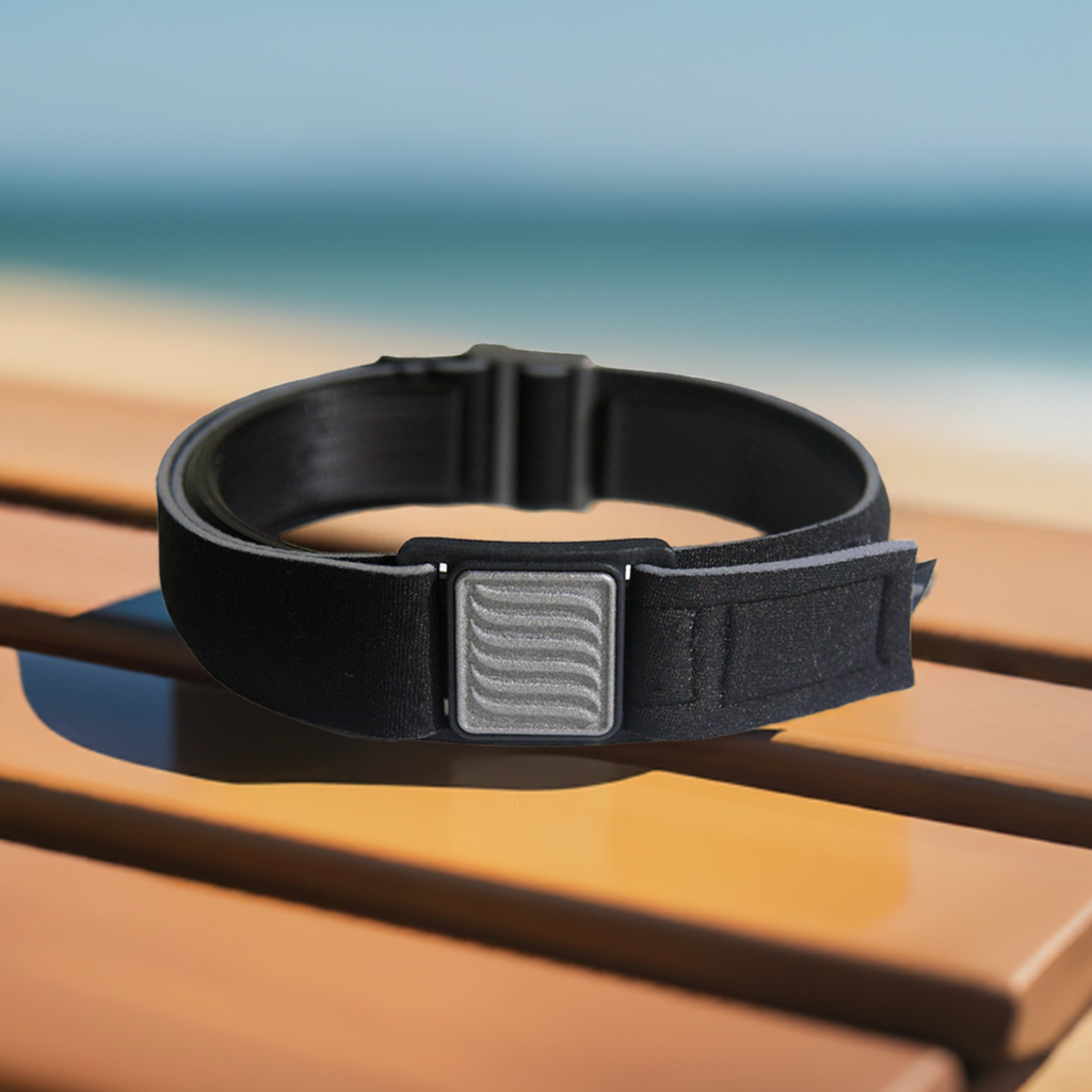 Libreband Armband for Freestyle Libre 3, shown in beach scene. Pewter cover with wave design.