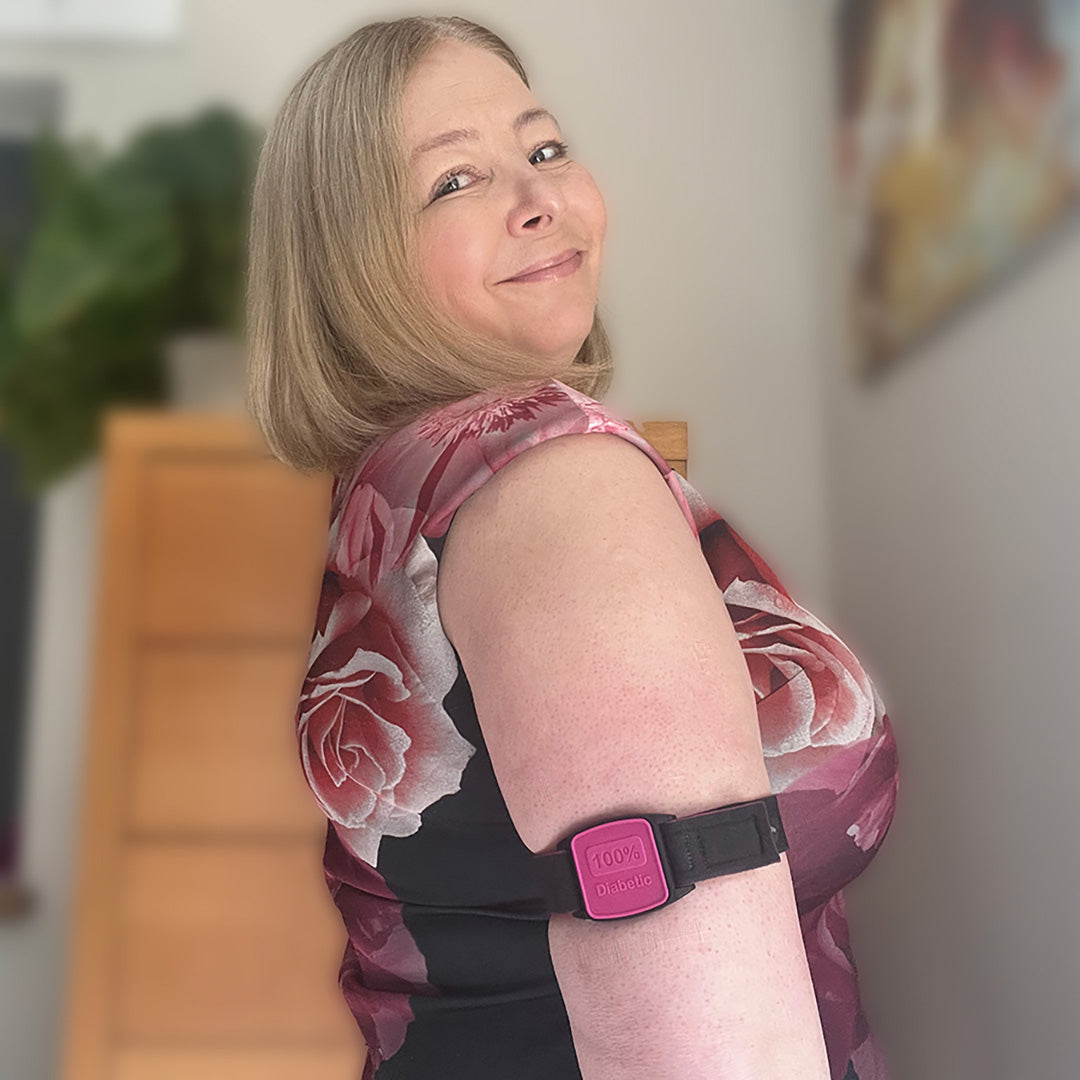 Model wearing 100% Diabetic armband cover in magenta and black strap.