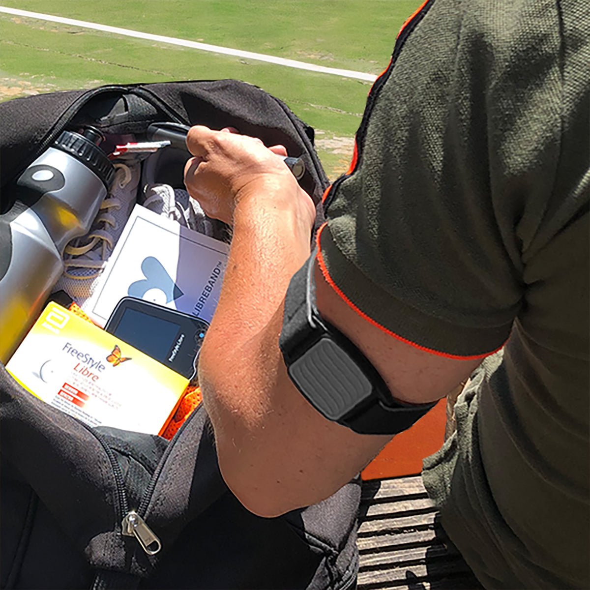 Libreband CGM armband for FreeStyle Libre 2 with pewter wave cover and neoprene strap worn on upper arm playing tennis