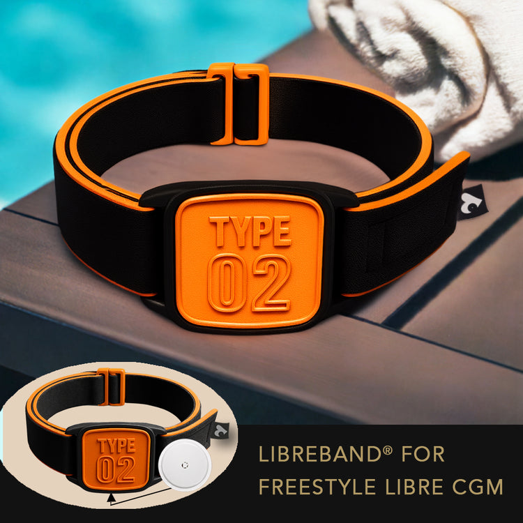Libreband CGM armband for FreeStyle Libre 2 with orange Type 02 cover and water-resistant neoprene strap on wooden lounger by swimming pool, next to towel